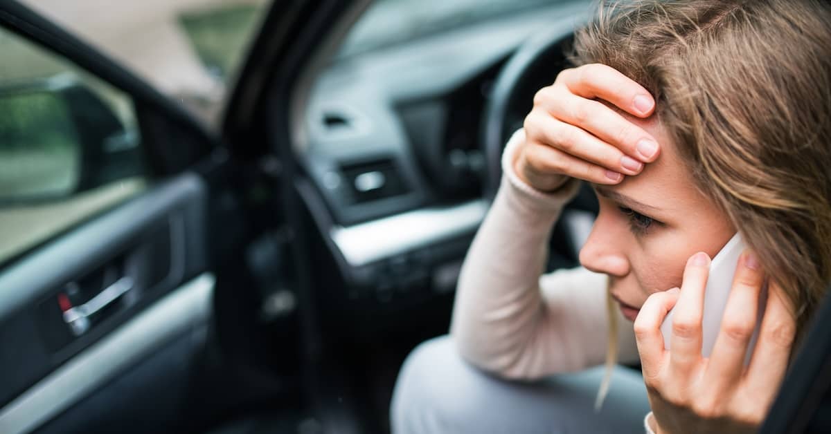 Woman on phone after car accident in Tennessee. | Bernheim Kelley Injury Lawyers