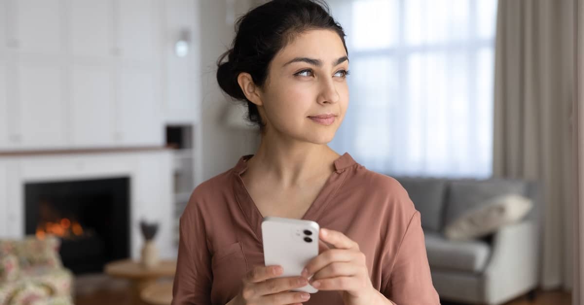 Woman with phone realizes she can get money for illegal robocalls and spam texts. | Bernheim Kelley