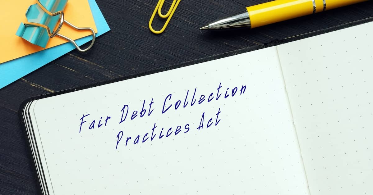 Notebook and writing says, Fair Debt Collection Practices Act. | Bernheim Kelley
