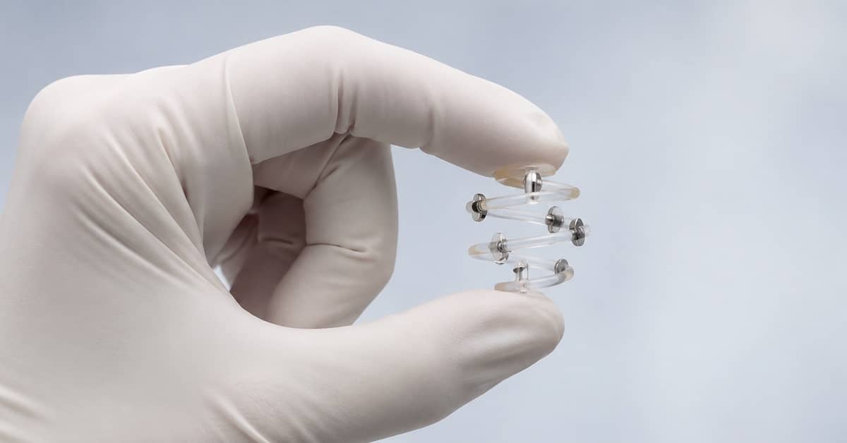 Gloved hand holding a BioZorb implant. | Bernheim Kelley