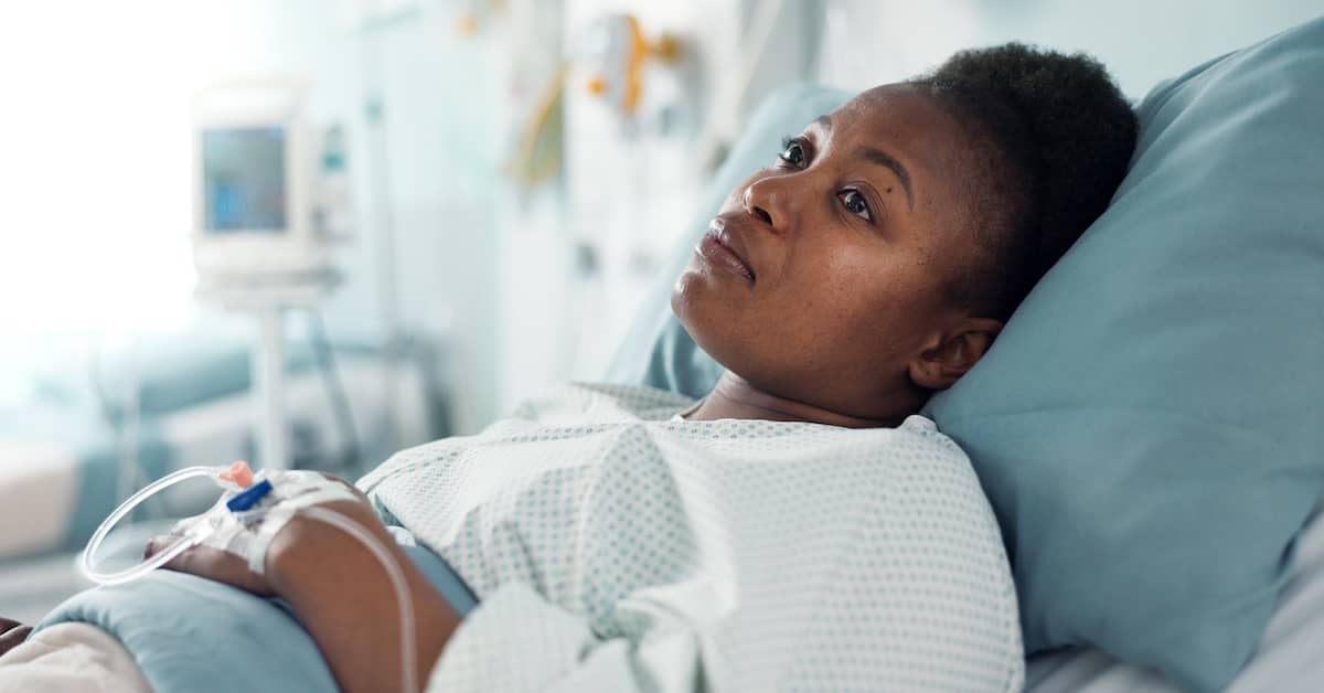 Woman in hospital bed after car accident injury. | Bernheim Kelley Injury Lawyers